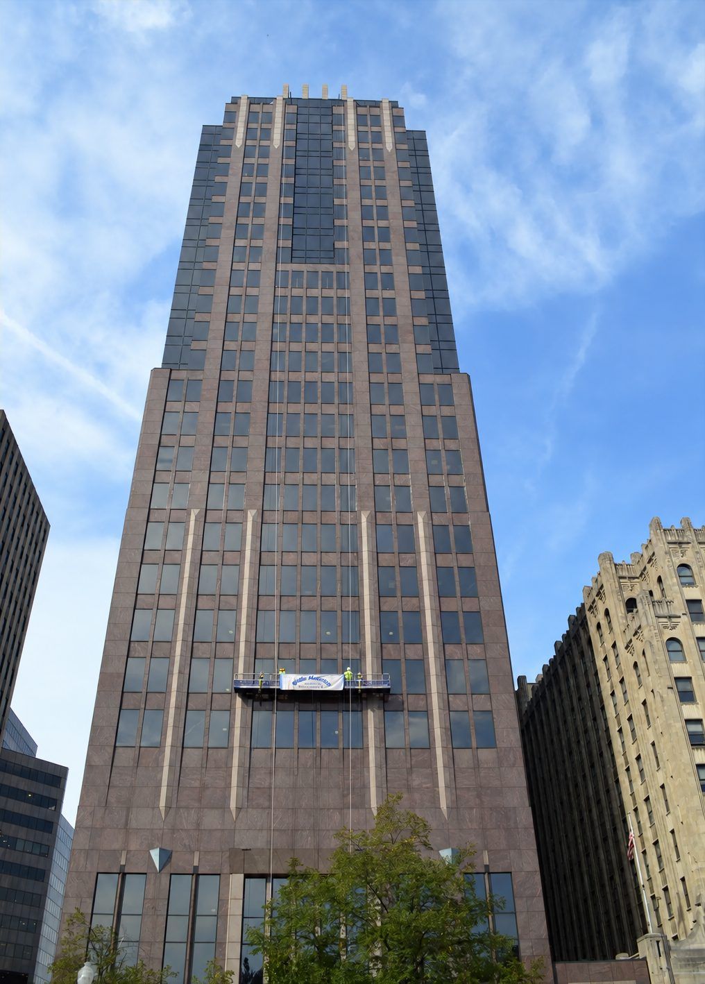 Wells crew on a swing stage restoring a downtown high-rise